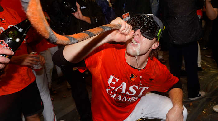 Orioles third baseman Gunnar Henderson drinks from the "Homer Hose" while celebrating his team's 2023 AL East championship